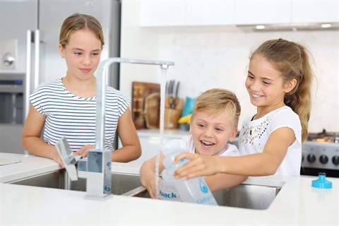 children-filling-water-bottles-at-kitchen-sink-1.jpg